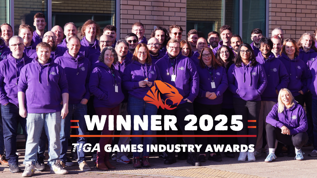 A team in purple hoodies behind a winner 2025 banner